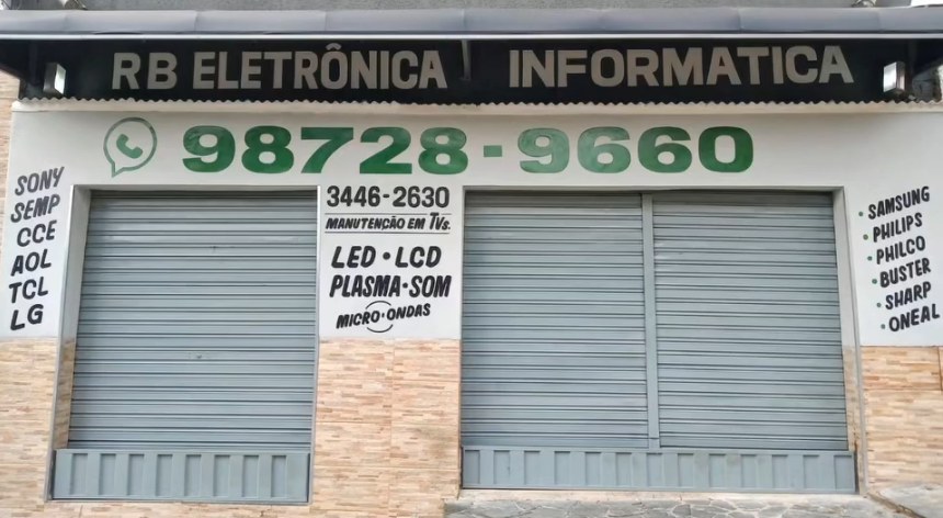 Fachada da loja RB Eletrônica, Informática e Automação na Rua Baependi, com o telefone 98728-9660 e as marcas atendidas pintadas na parede